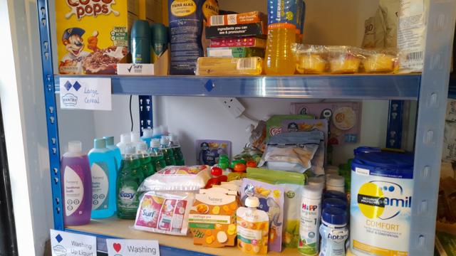 large cereal and washing powder on shelves with labels