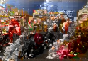 Group of people in Christmas clothes and Christmas toys