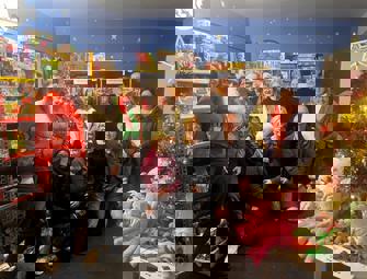 Group of people in Christmas clothes and Christmas toys