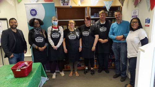 A group of people in Pantry aprons