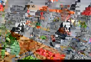 woman holding a basket with vegetables in front 