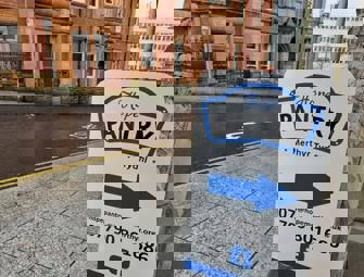 your local pantry sign outside with a blue arrow pointing to the side