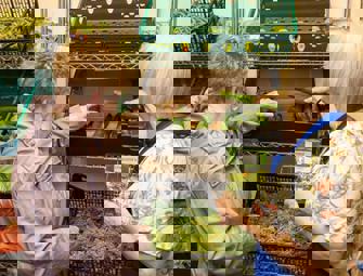 two woman reaching for food 