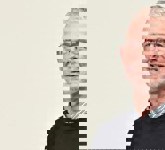 headshot of man in glasses wearing a black jumper 