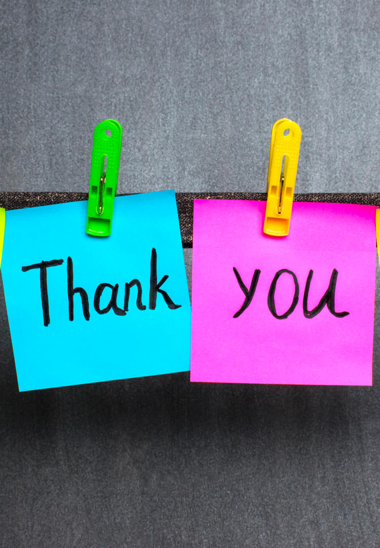 Thank You shown on post it notes on a clothes lines with a smiley face and exclamation mark