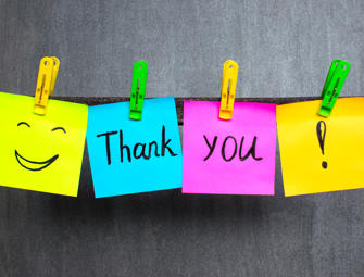 Thank You shown on post it notes on a clothes lines with a smiley face and exclamation mark