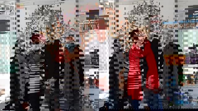 group of people inside a pantry wearing masks