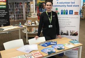 elena in front of a pantry banner and table