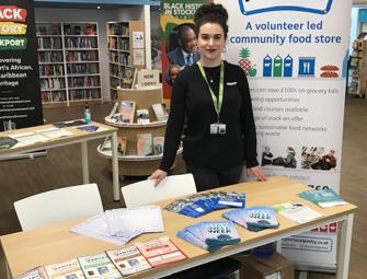 elena in front of a pantry banner and table