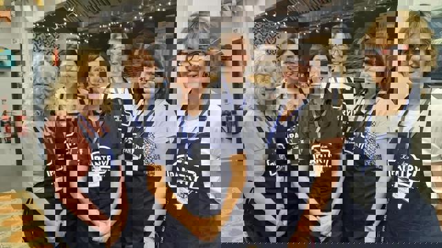 group of woman in blue aprons