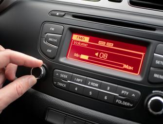 hand on a dial of a car radio