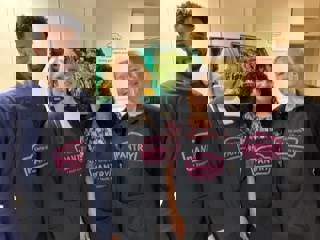 four people with black pantry aprons