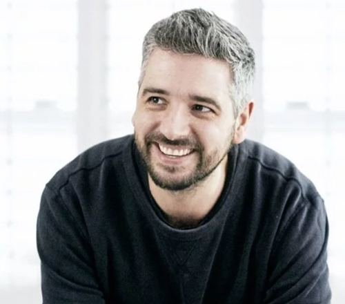 Miguel Barclay smiling in a black jumper