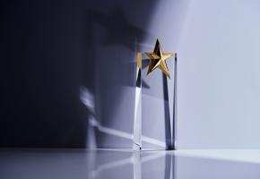 close up of an award trophy made of glass with a star on top