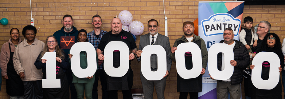 A line of people holding white cardboard numbers in the shape of 1,000,000