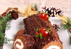 Christmas chocolate yule log on a white plate