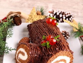Christmas chocolate yule log on a white plate
