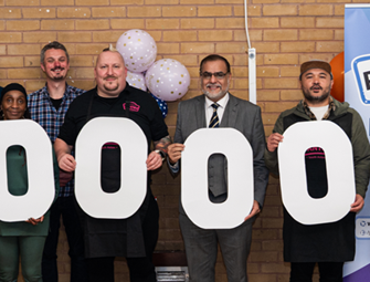 collection of people holding up letter signs to make the number one Million 