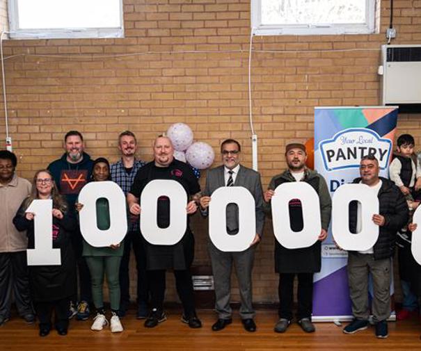 collection of people holding up letter signs to make the number one Million 