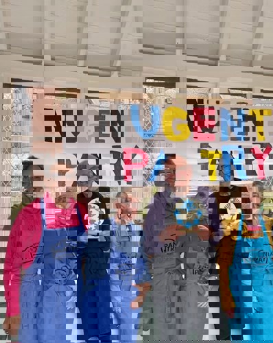 3 woman and a man holding a trophy