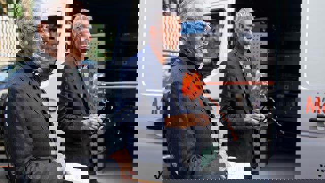 priest in front of ribbon 