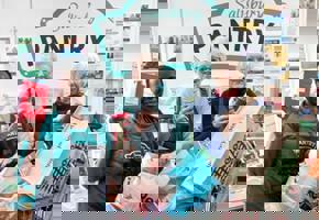 group of woman in front of pantry sign with trolley full of bags